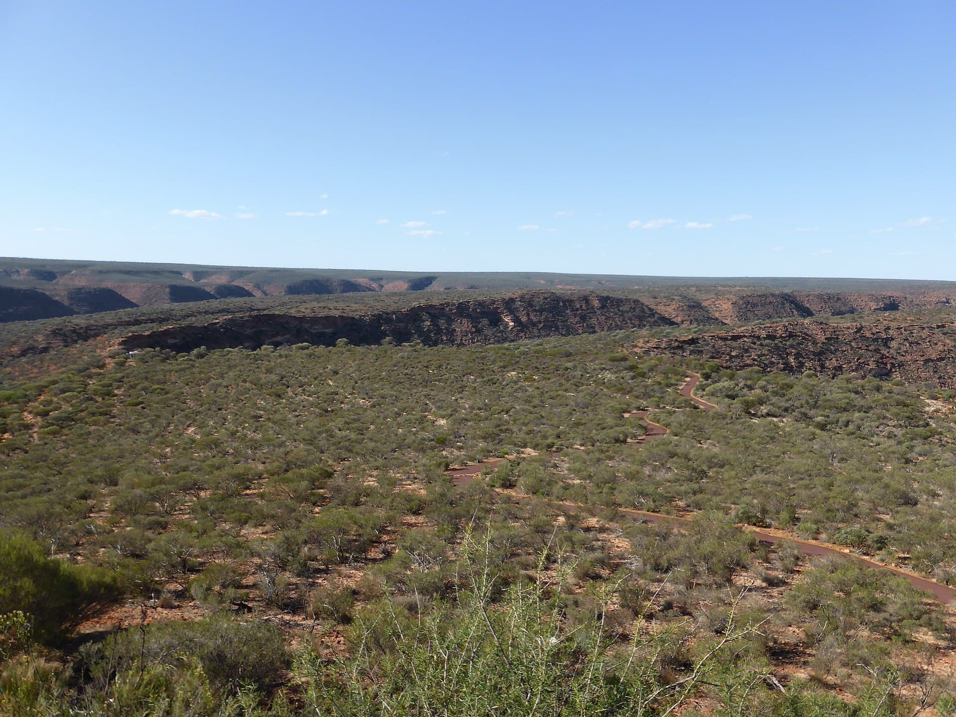 Red and white banded sandstone walls of the Murchison River Gorge